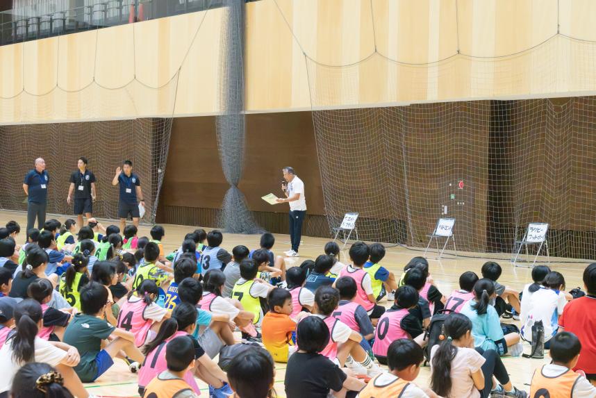 開始式にて参加児童が説明を聞いている画像