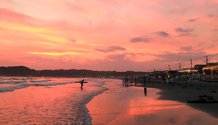 Walking along the beach while watching sunset in the early evening.2